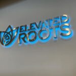 Backlit Wall Logo at Elevated Roots' Kingston Dispensary - Credit: Elevated Roots