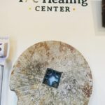 Antique Mill Stone at The Healing Center's Fitchburg Dispensary - Photo Credit: The Healing Center
